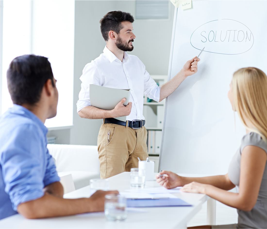 Team discussing solution on whiteboard